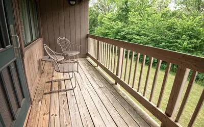 two chairs sitting on the porch of a house at Blue Licks Battlefield State Park in Carlisle