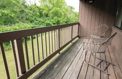 two chairs sitting on the porch of a house at Blue Licks Battlefield State Park in Carlisle
