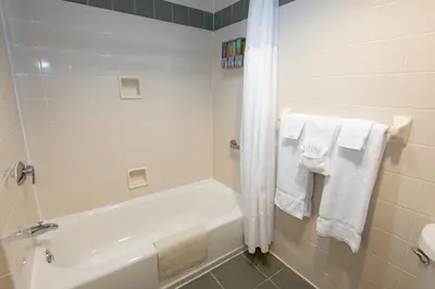 a bathroom with a bath tub and towels at Blue Licks Battlefield State Park in Carlisle