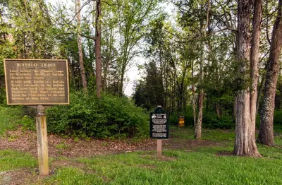 a sign in the grass next to a park at Blue Licks Battlefield State Park in Carlisle