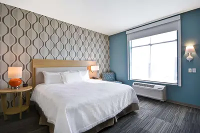 a bedroom with a large bed and a window at Home2 Suites by Hilton Perrysburg Levis Commons Toledo in Perrysburg