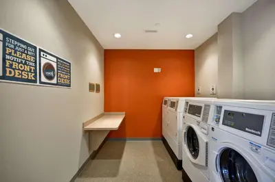 a laundry room with a washer and dryer at Home2 Suites by Hilton Perrysburg Levis Commons Toledo in Perrysburg