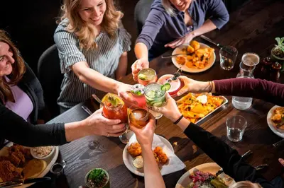 a group of people sitting around a table with drinks at Courtyard Fort Wayne Downtown at Grand Wayne Convention Center in Fort Wayne