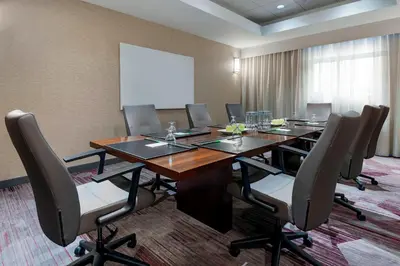 a conference room with a long wooden table and chairs at Courtyard Fort Wayne Downtown at Grand Wayne Convention Center in Fort Wayne