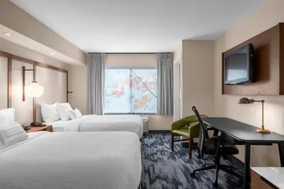 a hotel room with two beds and a desk at Fairfield by Marriott Inn & Suites Columbus Hilliard in Columbus