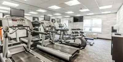 a gym with treadmills and machines in a room at Fairfield by Marriott Inn & Suites Columbus Hilliard in Columbus