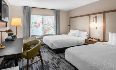 a hotel room with two beds and a desk at Fairfield by Marriott Inn & Suites Columbus Hilliard in Columbus