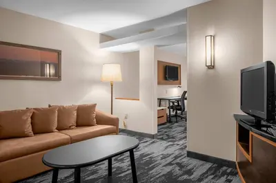 a living room with a couch and a tv at Fairfield by Marriott Inn & Suites Columbus Hilliard in Columbus