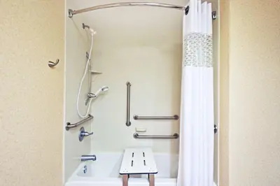 a bathroom with a tub and a shower with a shower curtain at Hampton Inn Huntington/Barboursville in Barboursville