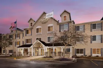 a rendering of the courthouse hotel at dusk at Country Inn & Suites by Radisson, Springfield, OH in Springfield