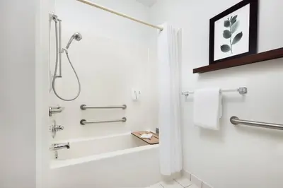 a white bathroom with a shower and a bathtub at Country Inn & Suites by Radisson, Springfield, OH in Springfield