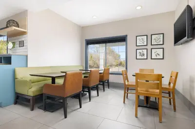 a dining room with a table and chairs at Country Inn & Suites by Radisson, Springfield, OH in Springfield