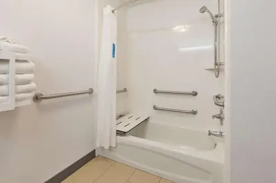 a bathroom with a shower and a bath tub at Hampton Inn Cincinnati Airport-North in Hebron