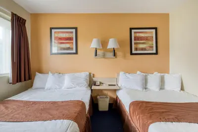 a hotel room with two beds and a window at Days Inn by Wyndham New Philadelphia in New Philadelphia