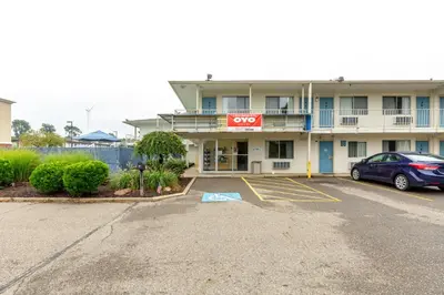 a hotel with a car parked in a parking lot at Days Inn by Wyndham New Philadelphia in New Philadelphia