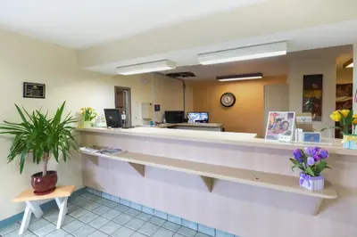 a waiting room with a counter in a hospital at Days Inn by Wyndham New Philadelphia in New Philadelphia