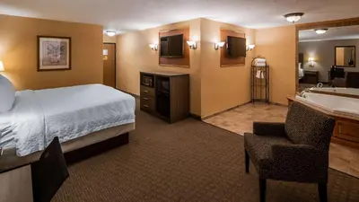 a hotel room with a bed and a bathroom at Best Western Plus North Canton Inn & Suites in North Canton