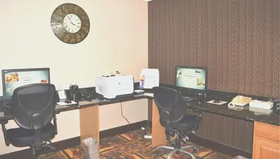 an office with two desks with two chairs and a clock at Comfort Inn, Cleveland South - Richfield in Richfield