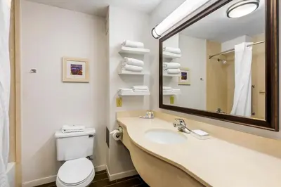a bathroom with a sink and a toilet and a mirror at Comfort Inn, Cleveland South - Richfield in Richfield
