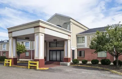 a house with a garage in front of it at Red Roof Inn Columbus - Ohio State Fairgrounds in Columbus