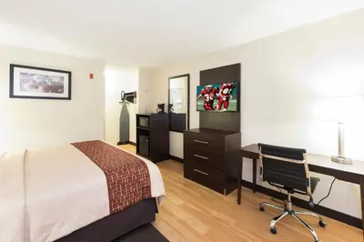 a hotel room with a bed and a desk and a computer at Red Roof Inn Columbus - Ohio State Fairgrounds in Columbus
