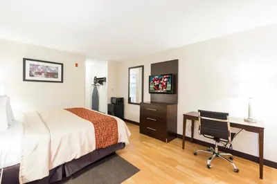 a hotel room with a bed and a desk at Red Roof Inn Columbus - Ohio State Fairgrounds in Columbus