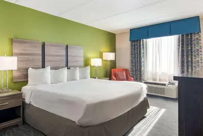a hotel room with a large bed and a window at Best Western Dutch Valley Inn in New Philadelphia