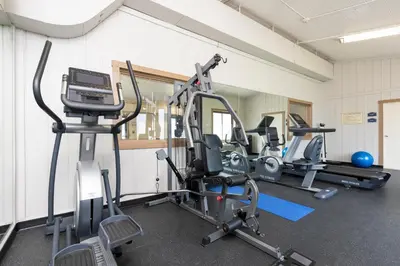 a gym with several treadmills and exercise machines at Best Western Dutch Valley Inn in New Philadelphia