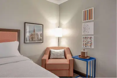 a hotel room with a bed and a chair at Hampton Inn by Hilton Washington Court House in Jeffersonville
