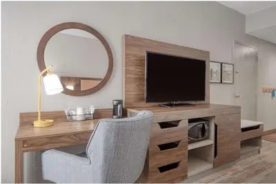 a room with a desk with a television and a mirror at Hampton Inn by Hilton Washington Court House in Jeffersonville