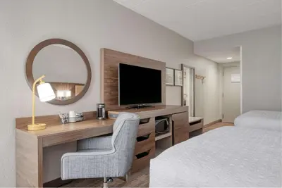 a hotel room with a desk with a television and a bed at Hampton Inn by Hilton Washington Court House in Jeffersonville