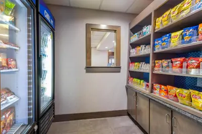 a store aisle of a store with food on shelves at Hampton Inn Akron-South in Akron