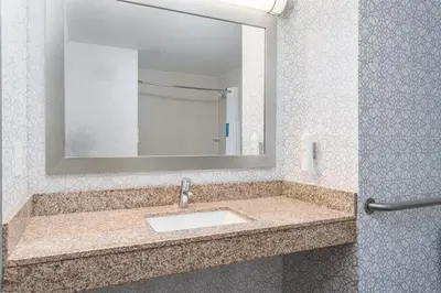 a bathroom with a sink and a mirror at Hampton Inn Akron-South in Akron