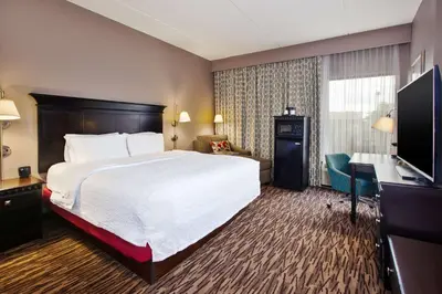 a hotel room with a bed and a television at Hampton Inn & Suites Cleveland-Airport/Middleburg Heights in Middleburg Heights
