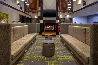 a waiting room with benches and a fireplace at Hampton Inn & Suites Cleveland-Airport/Middleburg Heights in Middleburg Heights
