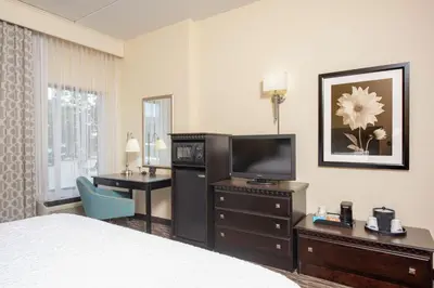a hotel room with a bed and a flat screen tv at Hampton Inn & Suites Cleveland-Airport/Middleburg Heights in Middleburg Heights