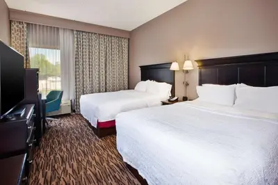 a hotel room with two beds and a flat screen tv at Hampton Inn & Suites Cleveland-Airport/Middleburg Heights in Middleburg Heights