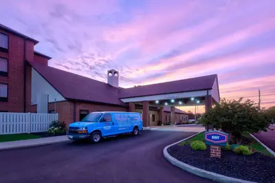 a blue van parked in front of a building at Hampton Inn & Suites Cleveland-Airport/Middleburg Heights in Middleburg Heights