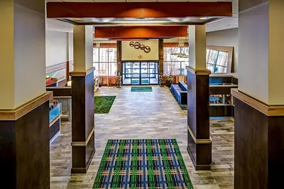a hallway of a building with a rug at Holiday Inn Cleveland Northeast - Mentor by IHG in Mentor