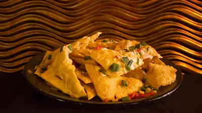 a plate of food with nachos on a table at Holiday Inn Cleveland Northeast - Mentor by IHG in Mentor