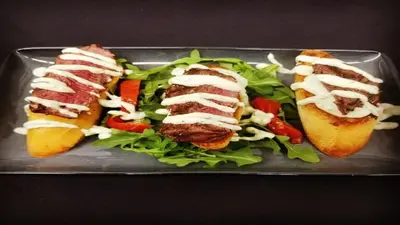 a plate of food with three sandwiches and a salad at Holiday Inn Cleveland Northeast - Mentor by IHG in Mentor