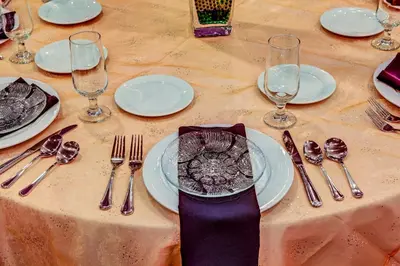 a table with plates and forks and spoons and glasses at Holiday Inn Cleveland Northeast - Mentor by IHG in Mentor