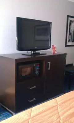 a flat screen tv on top of a dresser at Holiday Inn Cleveland Northeast - Mentor by IHG in Mentor