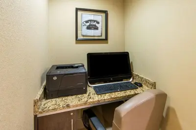 a desk with a laptop computer and a printer at Microtel Inn and Suites North Canton in North Canton