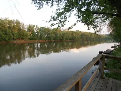 a view of a river with a wooden dock at Martin's River Cabin in Dresden