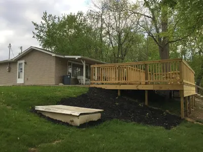 a wooden deck in the yard of a house at Martin's River Cabin in Dresden