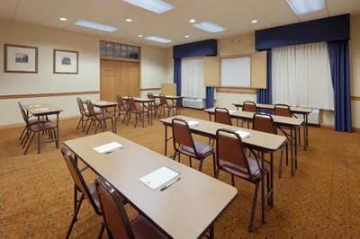 a classroom with tables and chairs in a room at Comfort Inn & Suites Cuyahoga Falls - Akron in Cuyahoga Falls