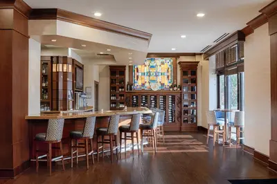 a bar in a library with chairs and a table at Residence Inn by Marriott Cincinnati Downtown/The Phelps in Cincinnati