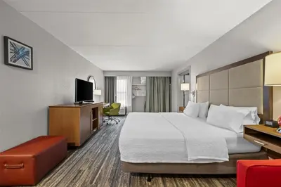 a hotel room with a bed and a television at Hampton Inn Toledo-South/Maumee in Maumee