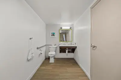 a white bathroom with a toilet and a sink at Hampton Inn Toledo-South/Maumee in Maumee